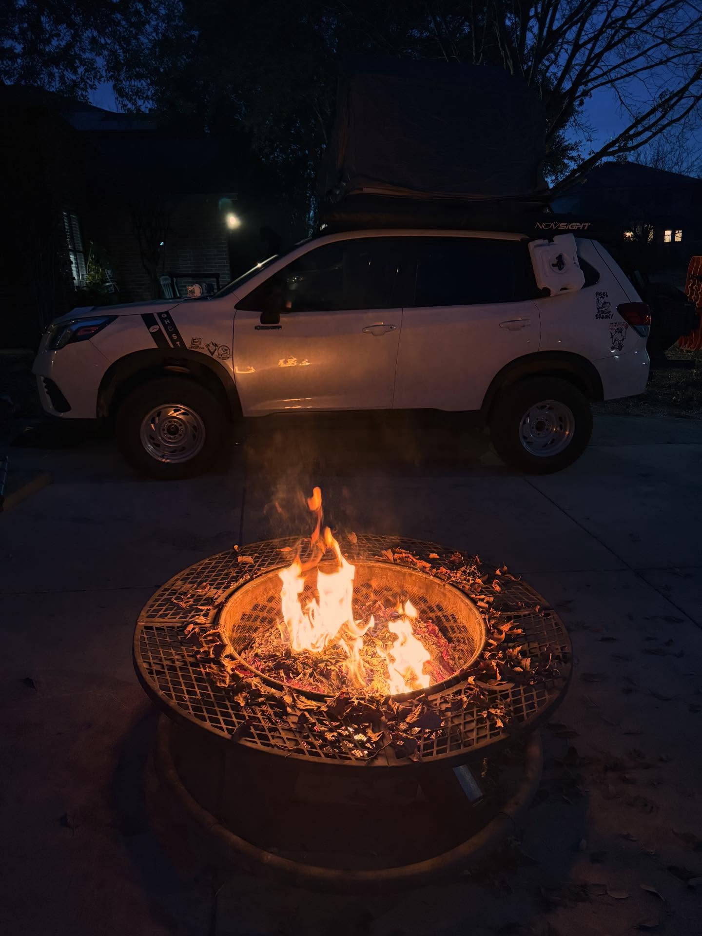 The Ghost glowing beside a campfire at night